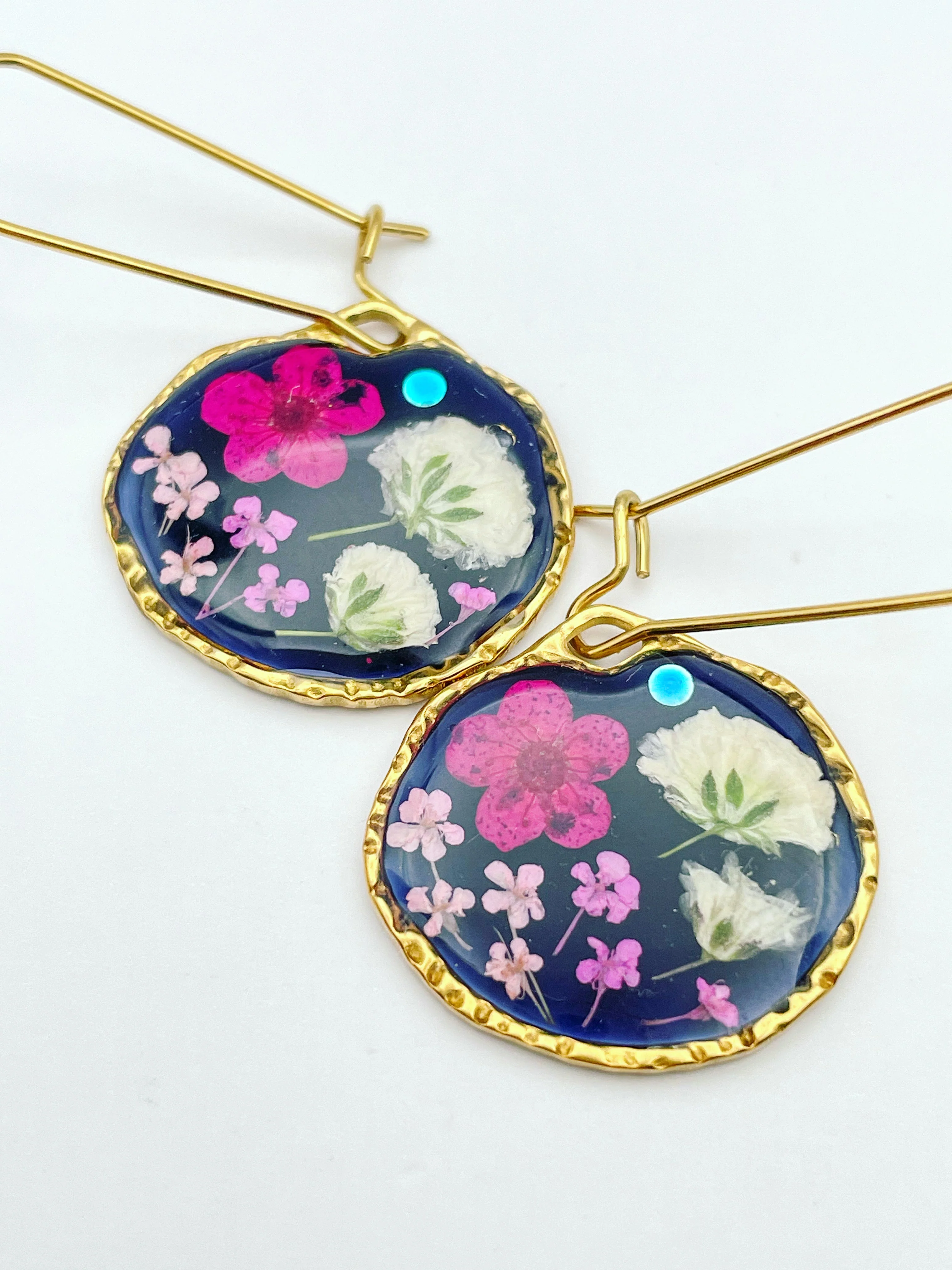 Black earrings with pink and white flowers