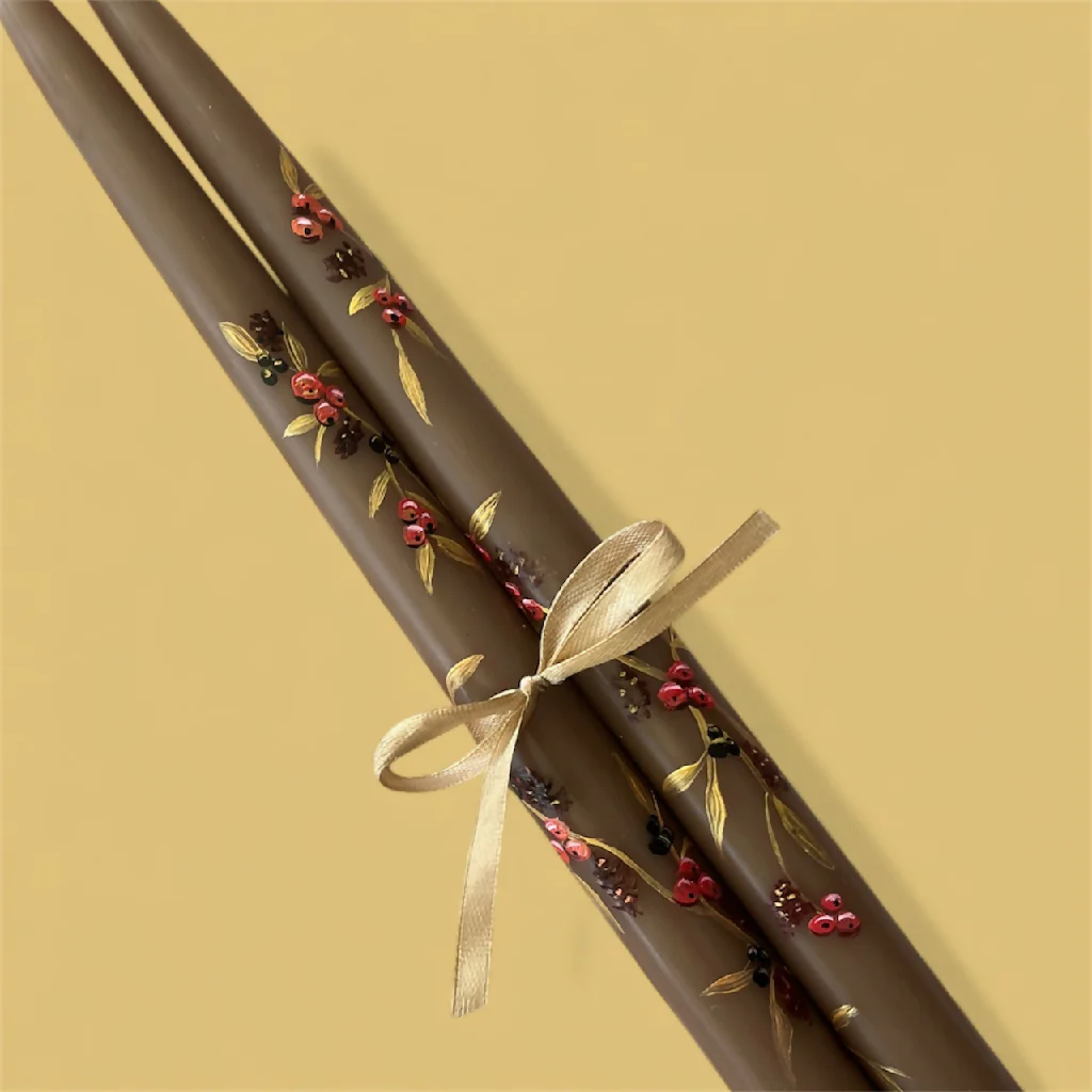 Hand painted pair of tapered brown candles with a berry design priced per pair