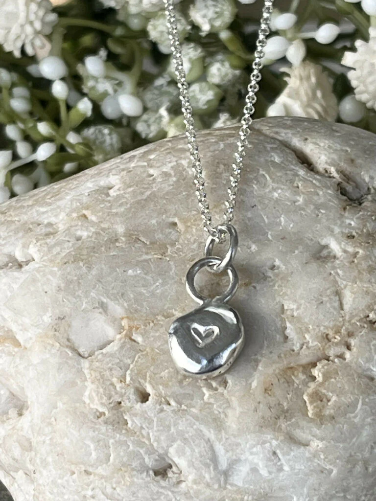 A handmade recycled fine silver hand stamped heart pebble pendant necklace. - Image 2