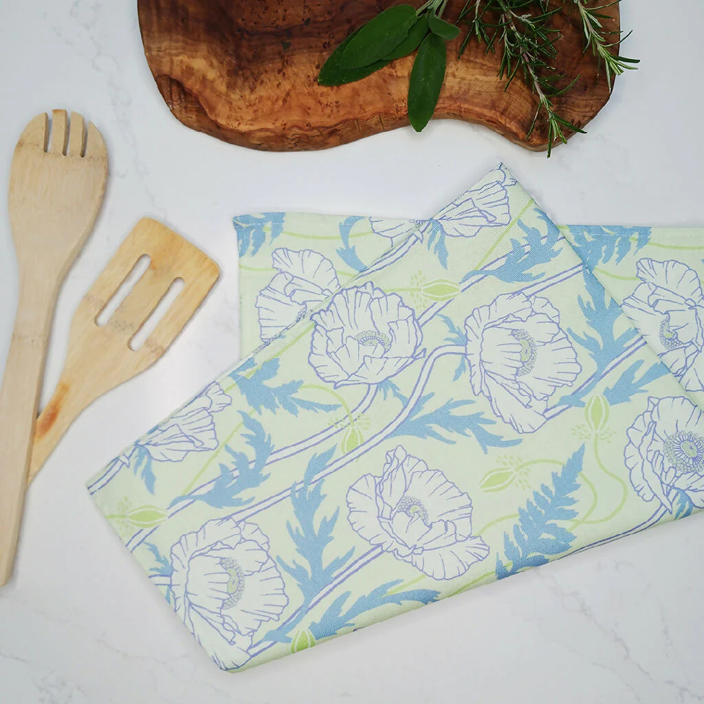 Poppy pattern tea towel in pale green/ blue