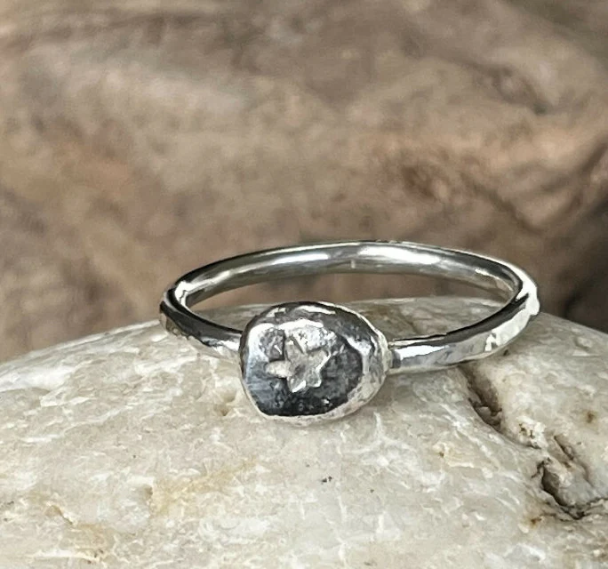 A recycled silver star stamped pebble ring size UK N