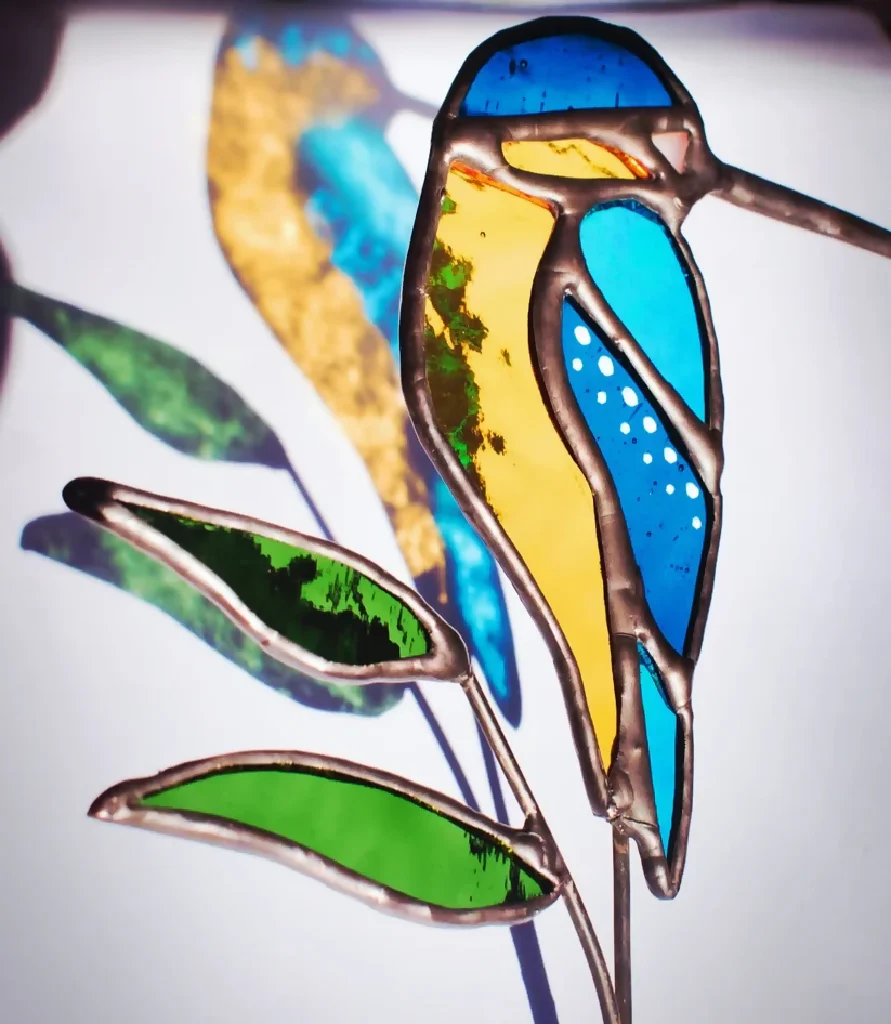 The Riverlight Kingfisher – Glass‑Winged Bird Resting on a Leafed Stem - Image 2
